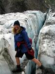 Cherie steps over a crack.  Glaciers, like English muffins, have lots of nooks and crannies.