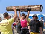 Marilyn Mickey is lifting a 110-pound log over her head, and doing multiple reps.