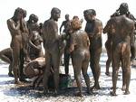 All 122 people where broken up into goups of 10 to take a mud bath in the "premium mud" supplied by the photographer.