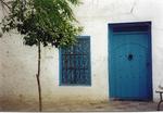 White washed houses with blue doors.