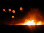 Jellyfish balloons floating off into the abyss of night.