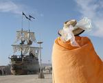 A caped man and a pirate ship, two everyday sightings in the middle of the desert.