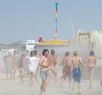 After a week in the desert, people chase after the water truck that drives by everyday.