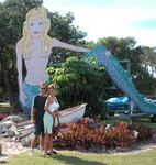 Greg and Cherie in front of a mermaid thing.
