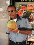 A security guard quenching his thirst with a coconut.