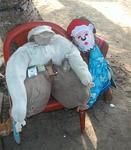 The Kunas made this effigy of their grandfather, to keep his spirit around.  They even put cigarettes in his hand and a bottle of water nearby. Next to him is a Kuna in a Santa mask we later purchased. 