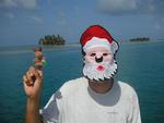 Greg with the Santa "Mola" mask and his reindeer finger-puppet.  (Whenever Greg darned this mask the Kuna children would scream: "Santa! Santa!")