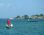 The Kuna Yala Santa cruising around the island in a canoe (sled?)  Notice the Kuna hiding in the bag pretending to be "the presents".