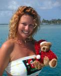 I'm holding a little bear (purchased in the US, made in China) that sings "We need a little Christmas, right this very minute..."  Also notice the "Santa mola" on my bathing-suit!