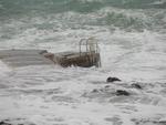 A cold front came in and brought high seas with it.  (That's the ladder divers climb up and down.)