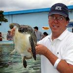 Tom playing with a turtle.