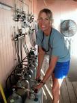 Captain Chris from "Reef Divers" filling the air tanks.  A woman's work is never done!