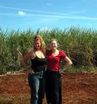 Cherie and Kristi with the red earth, green sugar cane and blue sky.