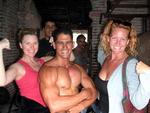 Kristi and Cherie make friends with the muscle men at a local gym.