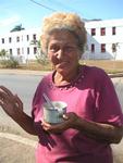 An old woman enjoying the sweetest part of her day--her ice-cream.