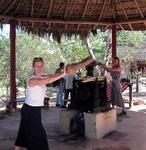 Kristi and Cherie crush the sugar cane into juice.