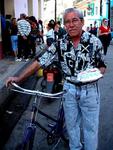 A man brings a birthday cake home to his son.