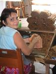 This lady transforms tobacco leaves into fine cigars.