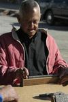 Man playing dominoes.