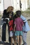 Cherie showing a bunch of little kids their image on her digital camera.