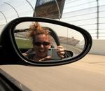 Cherie, a little windblown, after 10 laps in excess of 100 mph in Tom's Porsche.