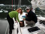 Cherie and Greg crank the handle, creating a creamy dessert for the entire crew to enjoy.