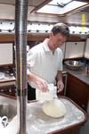 Rick in the galley making fresh sourdough bread.