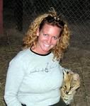 Cherie plays with an orphaned serval.