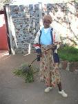 Zimbabwe woman sweeping the grounds.