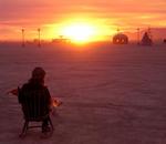 A woman and her baby watch the sunrise.