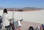 Nude people assemble in beautiful formations for an artist's photo.