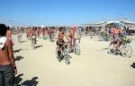 6,000 women ride their bikes topless through the playa on the annual "Critical Tits" bike-ride.