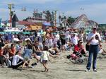 The fans wait by the boardwalk for the racers to finish.