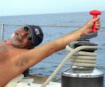 Dave stretches for the winch.  Sometimes sailing is almost like work!