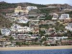 As we near Cabo, the barren land grows colorful houses.