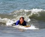 Cherie boards down a wave.