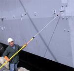 Workers prepare the USS Midway for its final voyage on January 10, 4002.