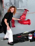 Cherie helps put on the final coat of paint for the aircraft carrier's last voyage. *Photo by Greg.