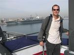 Greg, with an aircraft carrier in the distance.