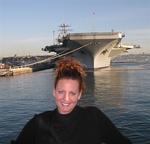Cherie in front of an aircraft carrier. *Photo by Greg.