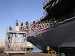 The Navy Band boards the USS Midway. 