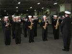 The Navy Band delights the crew with patriotic tunes.