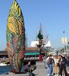 I snapped a shot of Jean photographing this art piece.  It's about the size I like my surfboard to be.  Coincidentally, the "urban tree" is called "Surfboard Cedar Survivor."