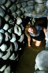 Cherie crawling through an Inca aquaduct in Peru.