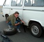 Dom fixes a flat on the Volksiebus we drove around in. *Photo by Kristi