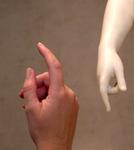 My hand juxtaposed against the marble curves of a statue.