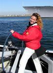 Cherie at the helm of America's Cup boat "Stars and Stripes." *Photo by Sherry