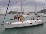 The crew of BVI Yacht Charters 2 (a Beneteau 505) waves as they enter Simpson Bay.