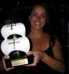 Carla holds up the Columbus Cup trophy.