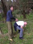 Not what you think.  He's holding up barbed wire!